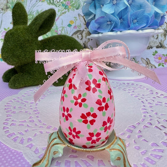 Small Hand Painted Egg Featuring Playful Red Flowers on a Delicate Pink Background