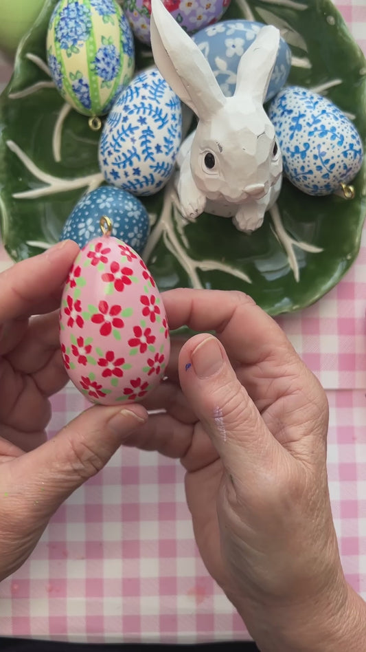 Small Hand Painted Egg Featuring Playful Red Flowers on a Delicate Pink Background