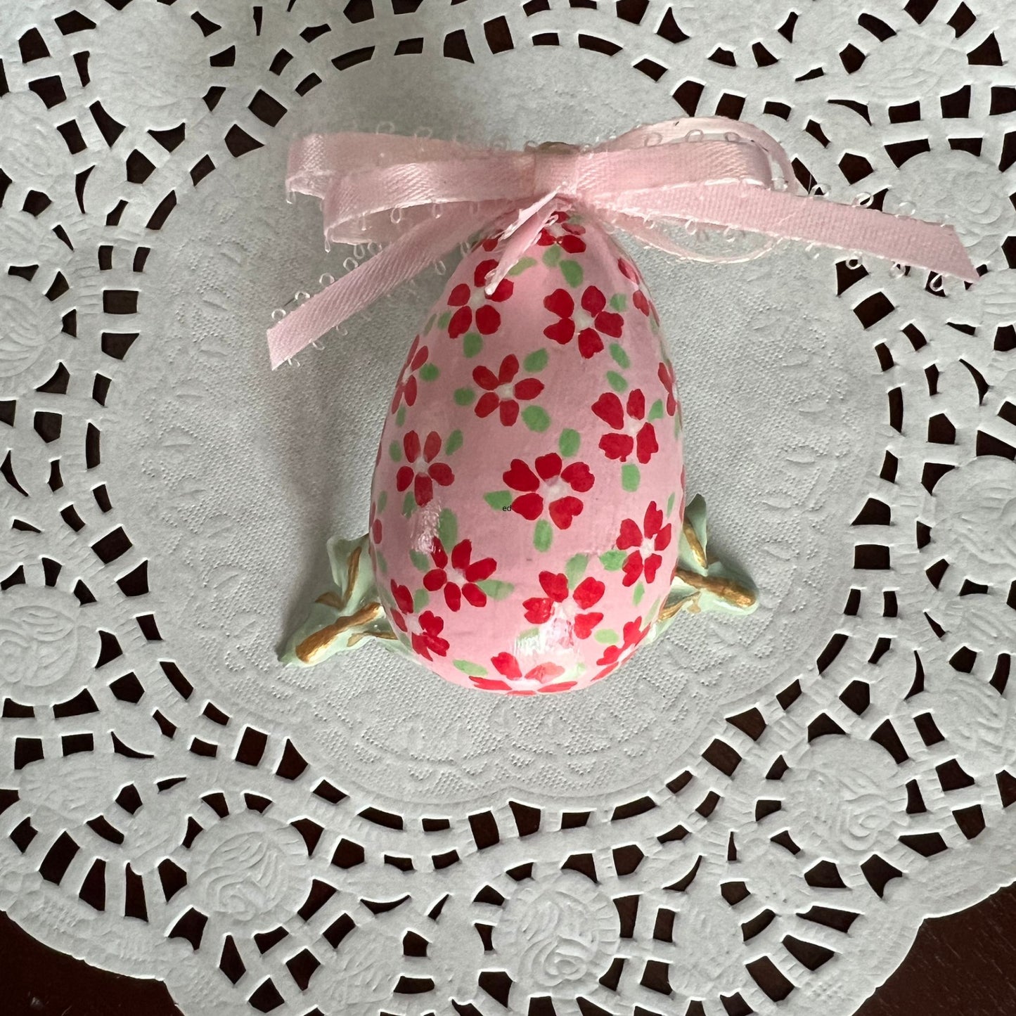 Small Hand Painted Egg Featuring Playful Red Flowers on a Delicate Pink Background